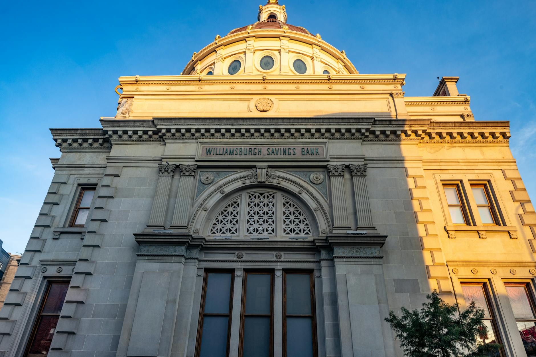 Detailed view of the historic Williamsburgh Savings Bank in Brooklyn, New York, captured at sunset.