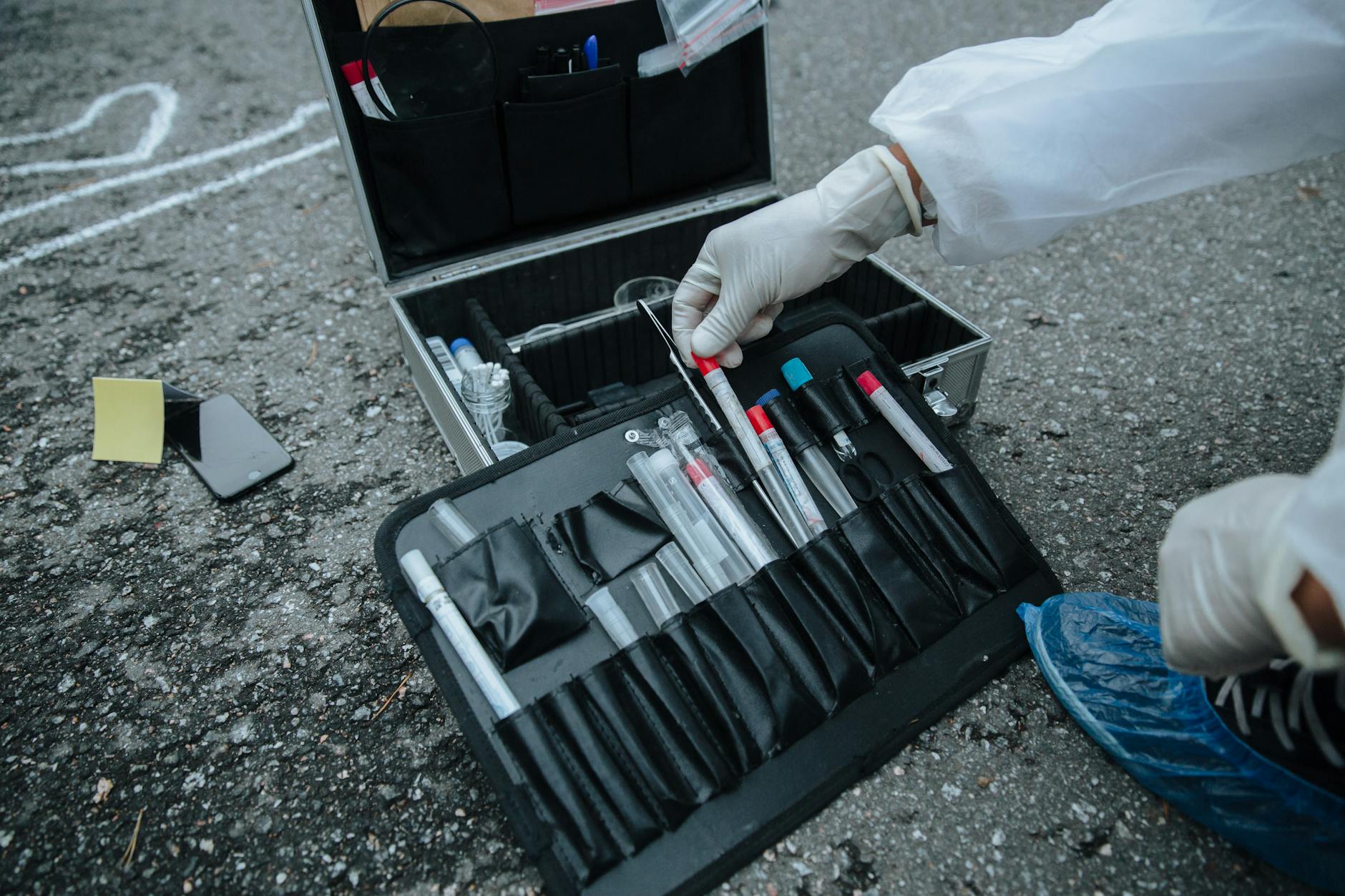 Close-up of investigator tools at a crime scene, showcasing precision and detail.